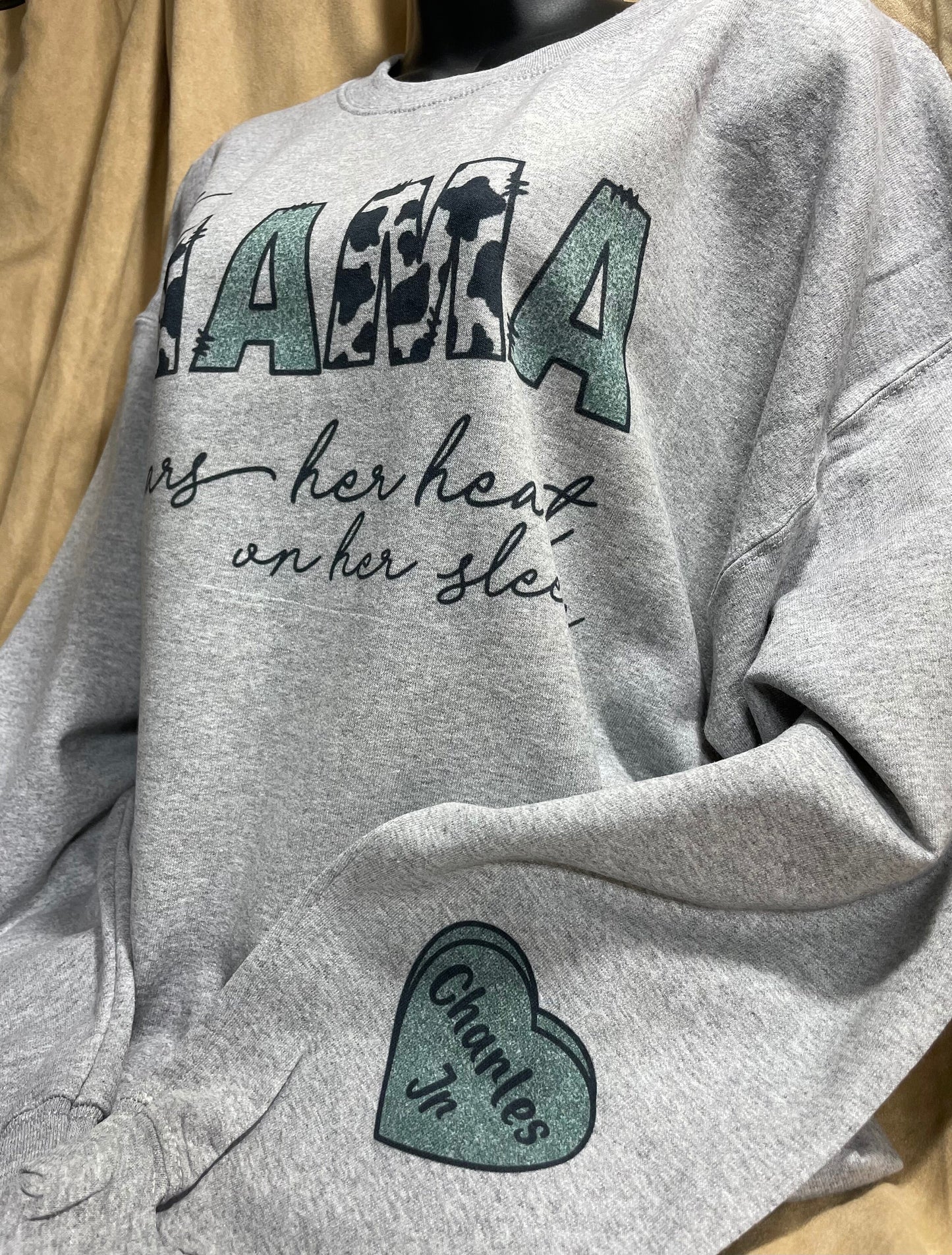 This MAMA wears her heart on her sleeve customizable/personalizeable Sweater sweatshirt tee in white or grey cow print.