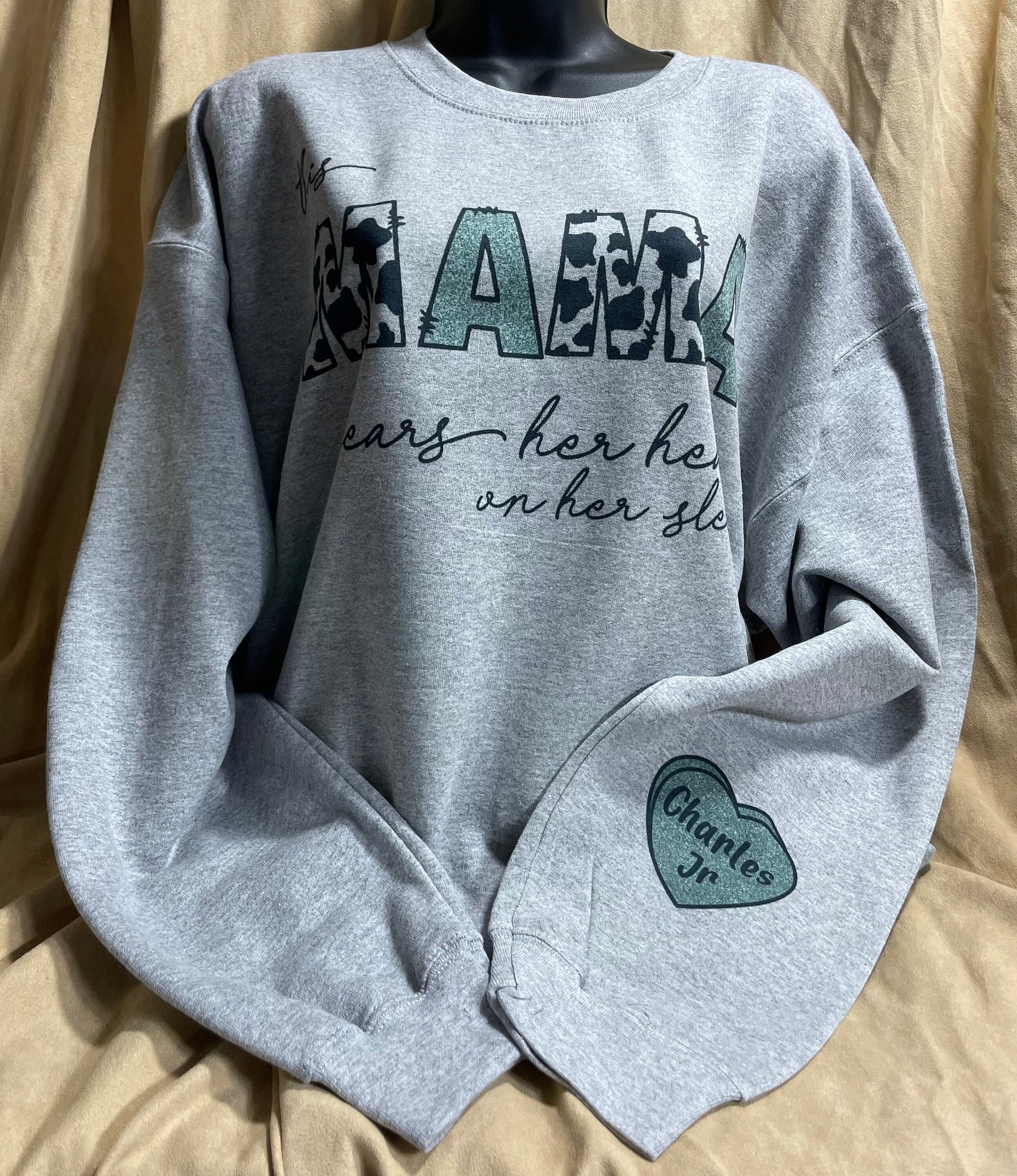 This MAMA wears her heart on her sleeve customizable/personalizeable Sweater sweatshirt tee in white or grey cow print.