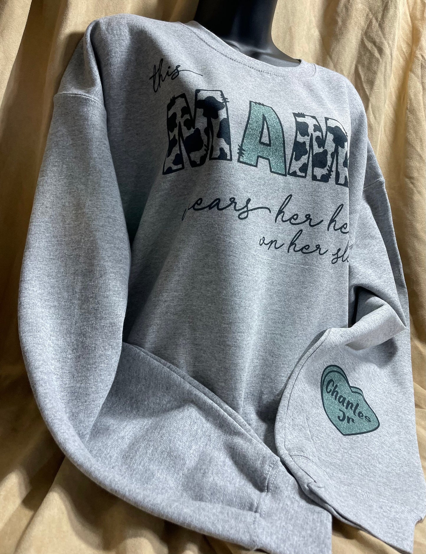 This MAMA wears her heart on her sleeve customizable/personalizeable Sweater sweatshirt tee in white or grey cow print.