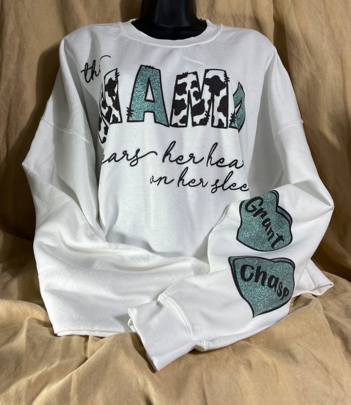 This MAMA wears her heart on her sleeve customizable/personalizeable Sweater sweatshirt tee in white or grey cow print.