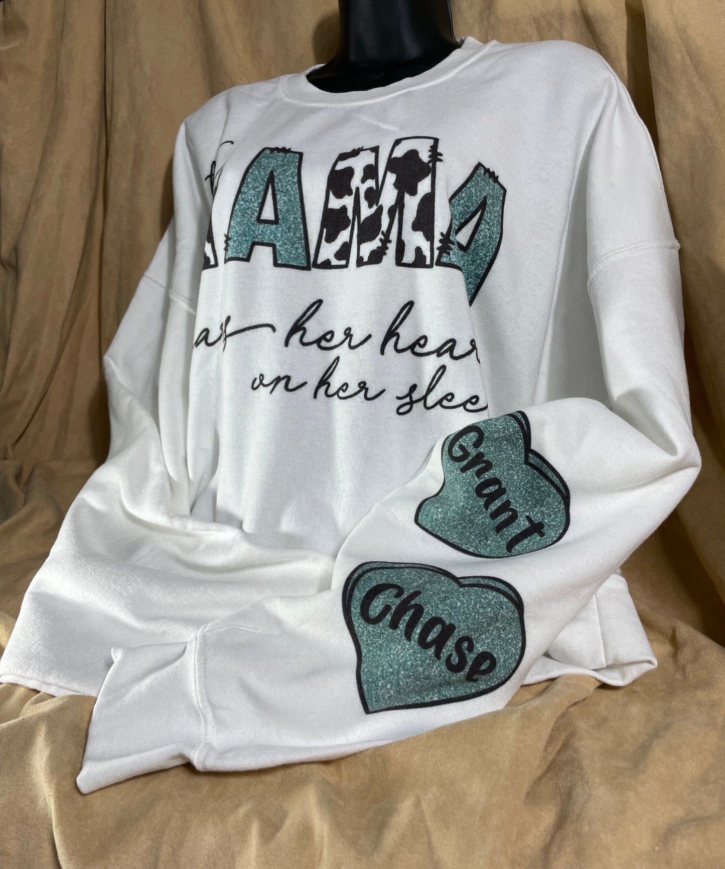 This MAMA wears her heart on her sleeve customizable/personalizeable Sweater sweatshirt tee in white or grey cow print.