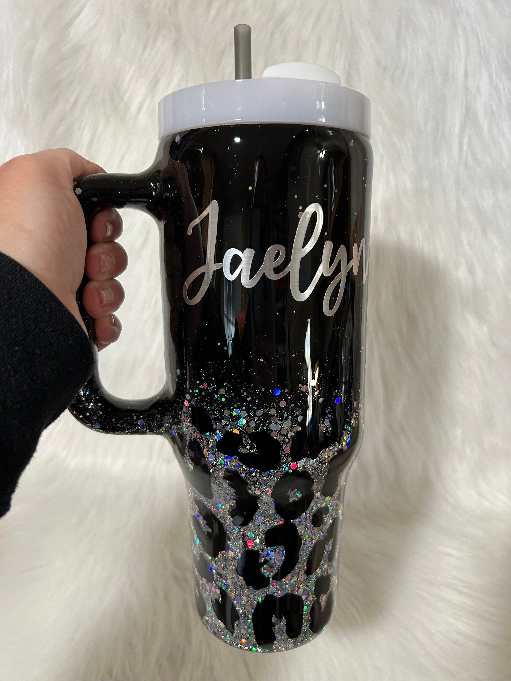 Leopard print tumbler on a black background and silver glitter, animal print cup, black and silver tumbler personalizeable with any name.