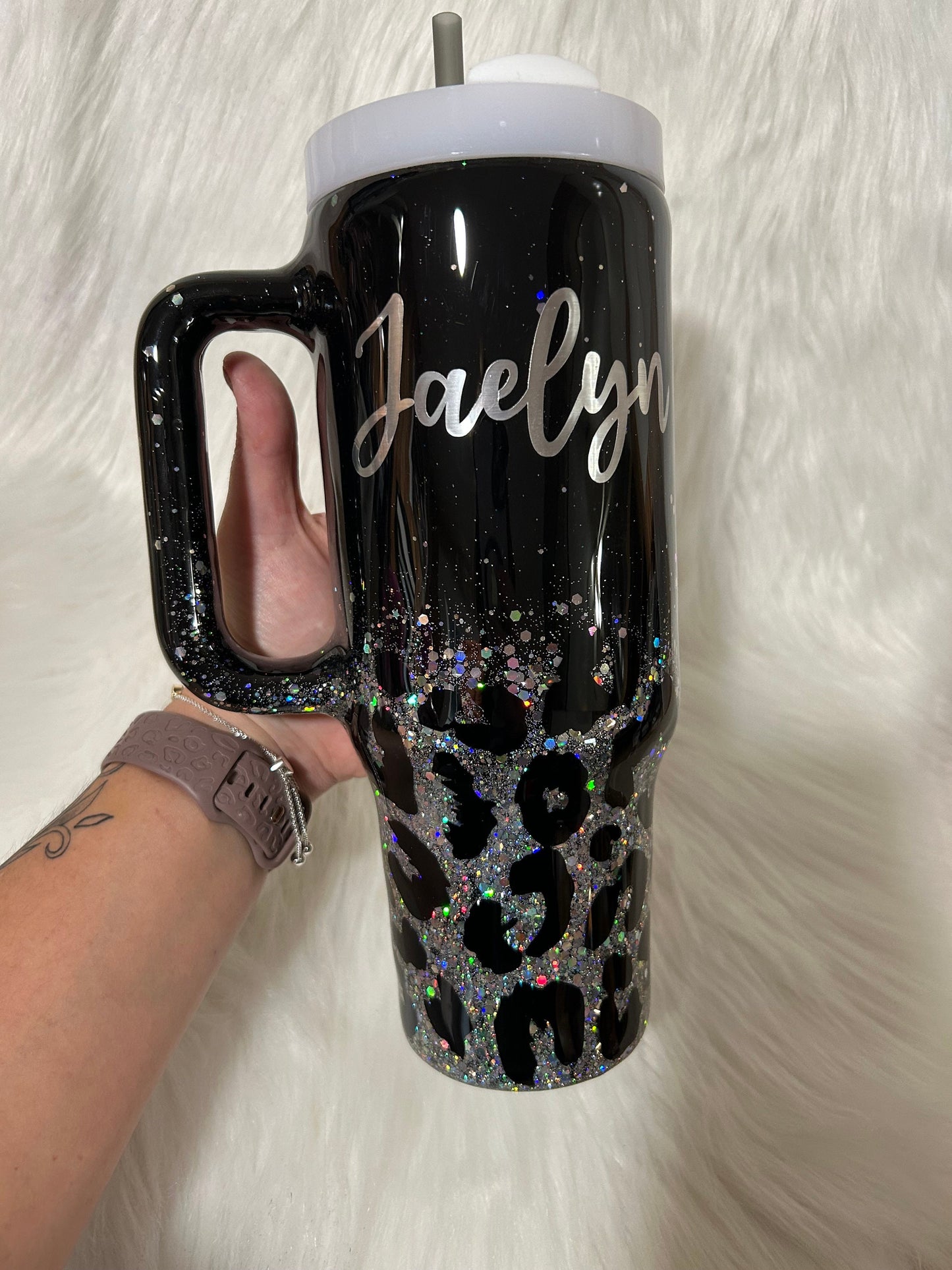 Leopard print tumbler on a black background and silver glitter, animal print cup, black and silver tumbler personalizeable with any name.